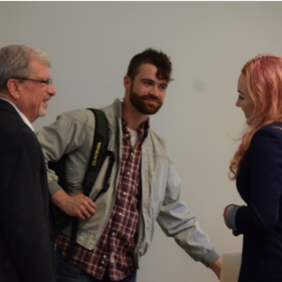 Three people conversing