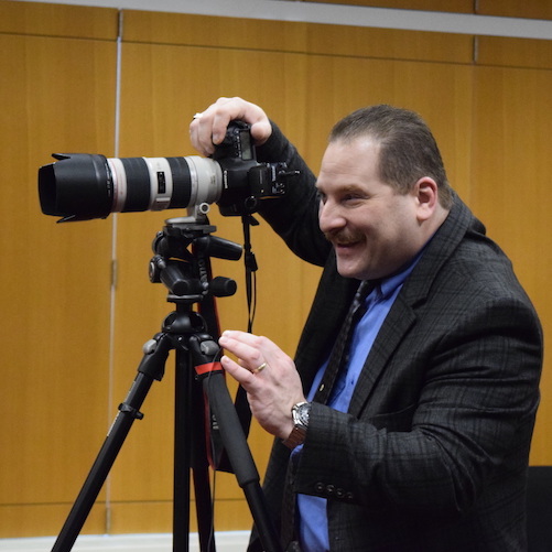 Mr. Roger Theise, photographer, taking a picture